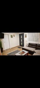 a living room with a couch and a coffee table at Vasilis House, Batković in Bijeljina