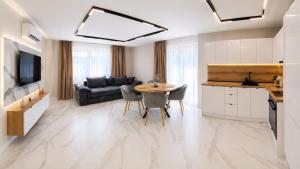 a living room with a table and a couch at Nikol River Residence in Sandanski