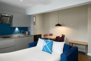 a living room and kitchen with a bed and a table at Four Points Flex by Sheraton Edinburgh in Edinburgh