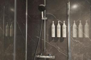 a shower with four bottles on the wall at Four Points Flex by Sheraton Edinburgh in Edinburgh +34 photos