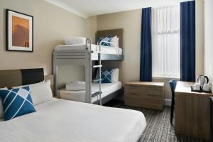 a hotel room with two bunk beds and a desk at Four Points Flex by Sheraton Edinburgh in Edinburgh