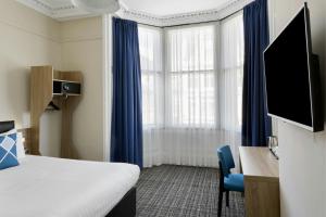 a hotel room with a bed and a tv at Four Points Flex by Sheraton Edinburgh in Edinburgh