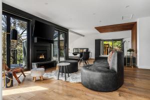 a living room with a couch and a fireplace at Istana Indulge in Hepburn Springs