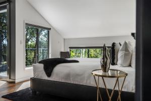 a bedroom with a bed and a glass table at Istana Indulge in Hepburn Springs