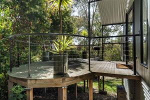 a bird cage on a deck next to a house at Istana Indulge in Hepburn Springs
