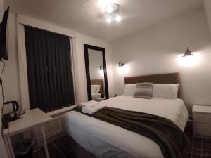 a bedroom with a large bed and a window at Central Stay Blackpool in Blackpool