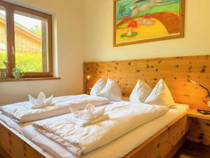 a bedroom with two beds with white pillows at Trebas 51 in Lake Pressegg