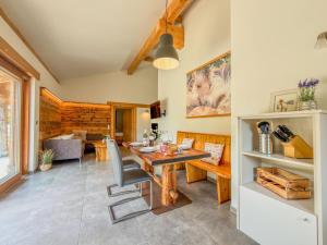 a dining room and living room with a table and chairs at Bellone 52 in Lake Pressegg