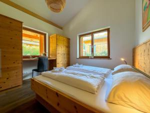 a bedroom with a large bed and a window at Bellone 52 in Lake Pressegg