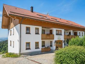 a large white house with a red roof at Max in Waldkirchen