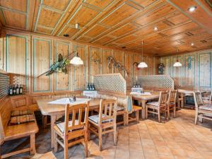 a restaurant with wooden walls and tables and chairs at Hans in Waldkirchen