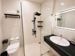 a bathroom with a toilet and a sink and a shower at Saffron Boutique Hotel in Da Lat +37 photos