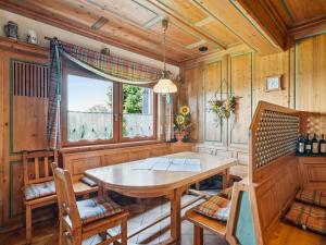a dining room with a wooden table and chairs at Traudi in Waldkirchen