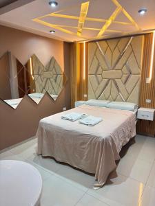 a bedroom with a bed with two towels on it at Inti killa in Huánuco