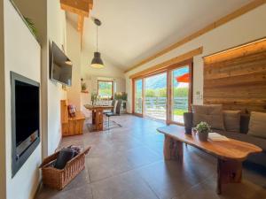 a living room with a couch and a table at Trebas 51 in Lake Pressegg
