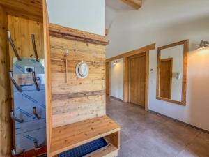 a room with a wooden wall with a washer and dryer at Trebas 51 in Lake Pressegg +49 photos