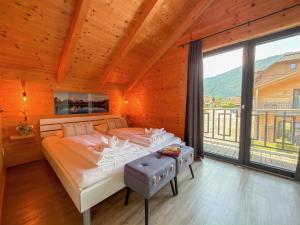 a bedroom with a bed and a large window at Rattendorf 23A in Rattendorf