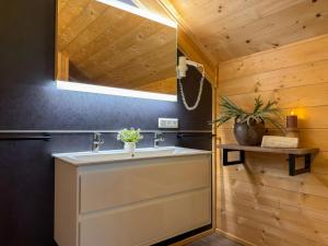 a bathroom with a sink and a wooden wall at Rattendorf 23A in Rattendorf +66 photos