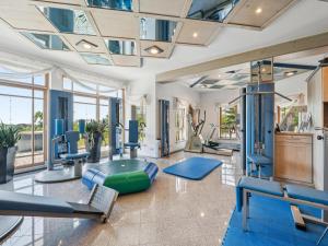 a gym with a lot of exercise equipment and windows at Max in Waldkirchen