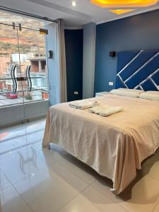 a bedroom with a large bed and a window at Inti killa in Huánuco