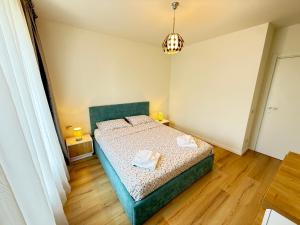 a bedroom with a bed with two towels on it at ThePlaceToBe2 in Brăila