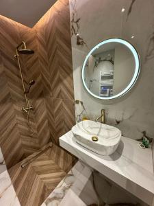 a bathroom with a sink and a mirror at SMART COASTAL RETREAT Apartment in Alexandroupoli +63 photos