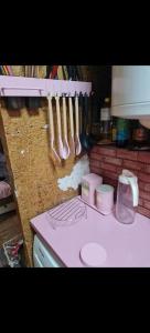 a kitchen counter with utensils hanging on a wall at Chata u Emi a Ivana in Tajov +18 photos
