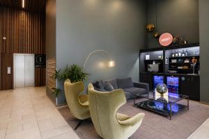 a living room with a couch and a table and chairs at Punthill Ivanhoe in Melbourne