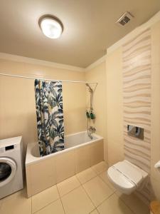 a bathroom with a toilet and a washing machine at ThePlaceToBe2 in Brăila +15 photos