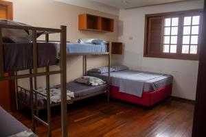 a room with three bunk beds and a window at Hostel Terraço Urbano in Sao Jose do Rio Preto