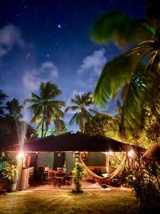 a house with a table and chairs at night at Casa Super Paradise in Rio Tinto