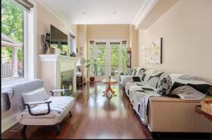 a living room with a couch and a fireplace at Unique Home - Upper Toronto Beaches in Toronto