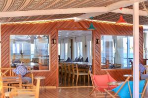 a restaurant with wooden walls and tables and chairs at Youssef Nile Boat in Luxor +62 photos