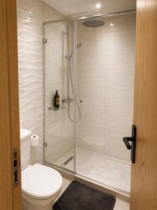 a bathroom with a glass shower with a toilet at Modern Studio Hassan Rabat in Rabat +3 photos