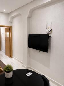 a living room with a flat screen tv on a wall at Modern Studio Hassan Rabat in Rabat