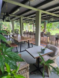 an outdoor patio with tables and chairs and tablesktop at Bramston beach resort in Bramston Beach