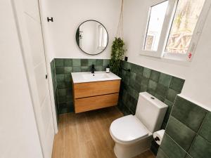 a bathroom with a toilet and a sink and a mirror at Apartamento Torrox Village 2 in Torrox +10 photos