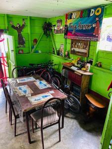 a dining room with green walls and a table and bikes at Casa cerca de IRTRA in San Martín Zapotitlán