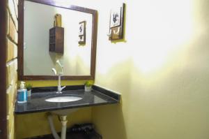 a bathroom with a sink and a mirror at A Casa Azul in Barra Grande +36 photos