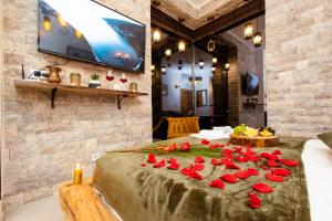 a room with a table with red roses on it at Countryside in Ulcinj