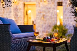 two glasses of wine on a table on a patio at Countryside in Ulcinj