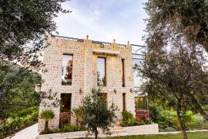 a brick house with trees in front of it at Countryside in Ulcinj