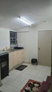 a kitchen with a sink and a stove at Tiny house in Paramaribo