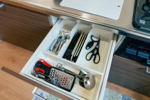 a drawer with scissors and other tools in it at ビアンカ Bianca A号室 in Asahikawa +29 photos
