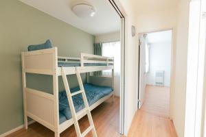 a bedroom with bunk beds and a mirror at ビアンカ Bianca A号室 in Asahikawa