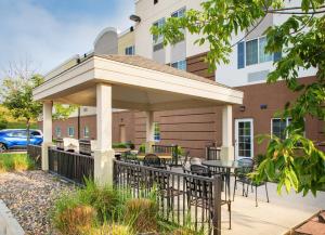 a pavilion with tables and chairs in front of a building at Candlewood Suites Bellevue by IHG in Bellevue