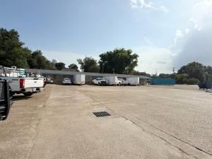 a building with cars parked in a parking lot at Budget Inn in Vidalia