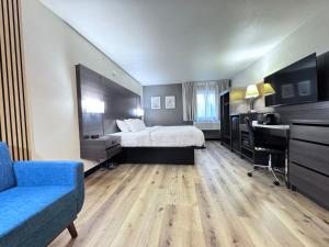 a hotel room with a bed and a desk at Quality Inn Spearfish I-90 in Spearfish +29 photos