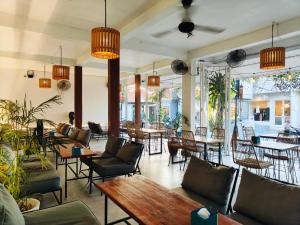 a restaurant with couches and tables and chairs at Ashana Hotel in Uluwatu