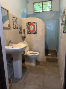 a bathroom with a toilet and a sink at Mustapha' s Place in Bwejuu +101 photos